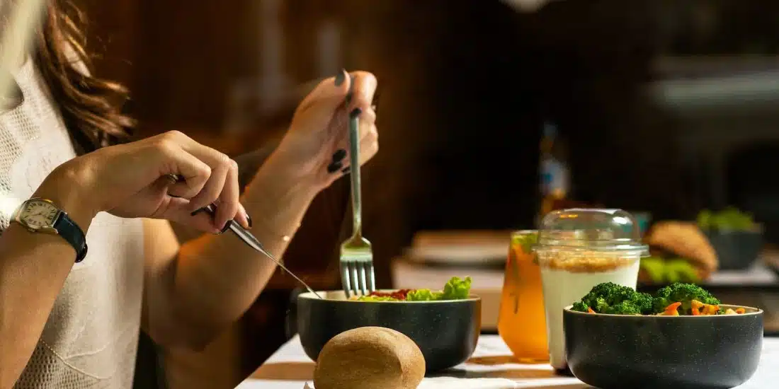 person holding silver fork and knife